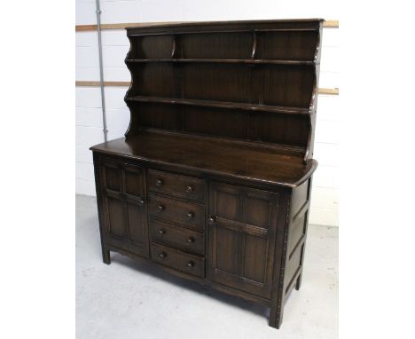 An Ercol 'Old Colonial' dresser, two plate racks over four drawers with panelled cupboard door to either side, 170 x 146cm.