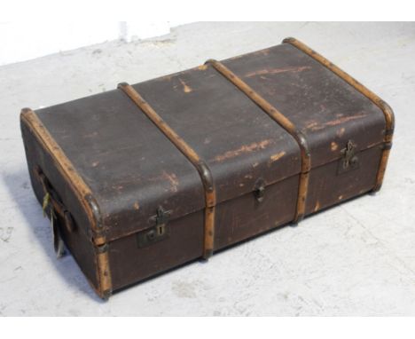 A vintage brown wood travel trunk with original label, length 94cm.
