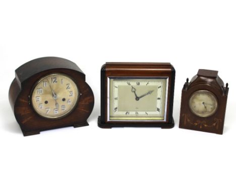 Three early-to-mid 20th century mantel clocks to include an oak-cased eight-day Art Deco style example, the silvered dial set