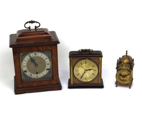 An early 20th century mahogany-cased eight-day mantel clock, stepped top with gilded carrying handle above silvered and gilde