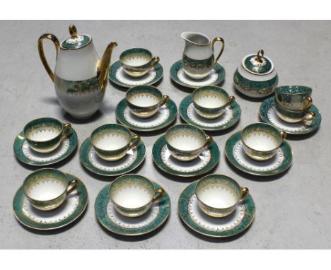 A Limoges green and gilt heightened coffee service to include coffee pot and twelve cups and saucers.