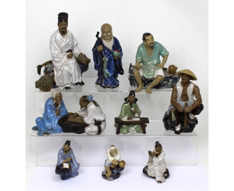 Nine contemporary Oriental ceramic figures in various poses (9).
