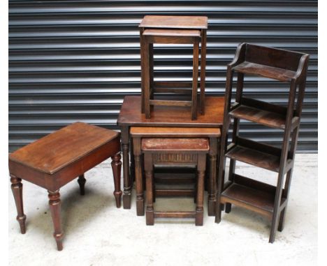 A nest of three priory-style oak tables, a nest of two small oak tables, a small early 20th century mahogany four-shelf unit 