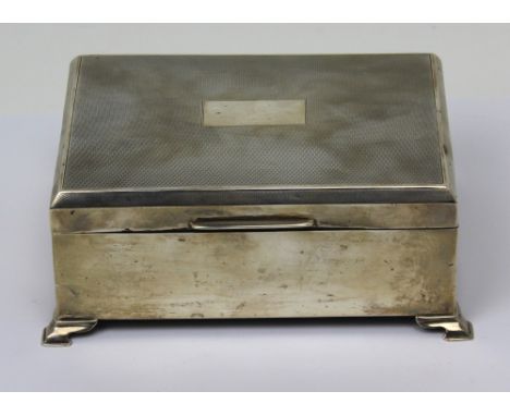 A George V hallmarked silver engine-turned cigar box with vacant cartouche to top, wood lining, on stepped supports, Birmingh