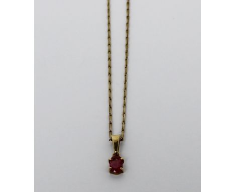 A 9ct yellow gold and ruby pendant on a 9ct yellow gold chain, length 40cm, boxed and with original receipt.