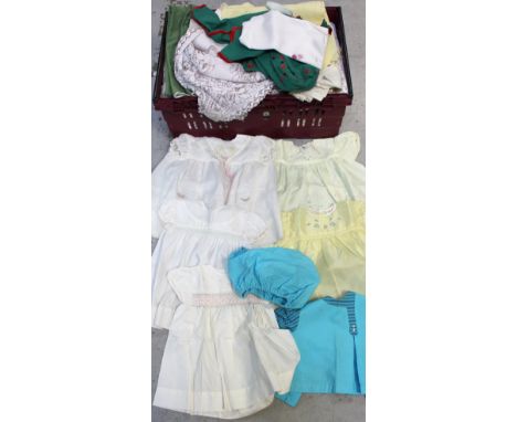 A quantity of textiles to include a number of girls' formal dresses and further loose unboxed fabric.