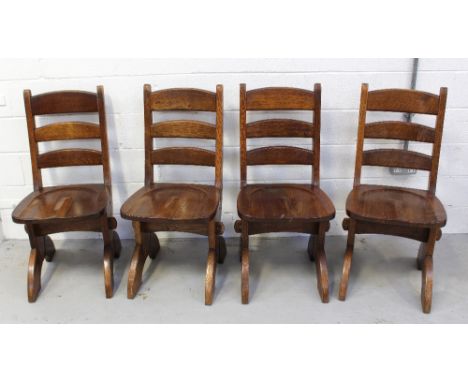 A set of four oak country-style kitchen/dining chairs with curved ladder back to slab supports (4).