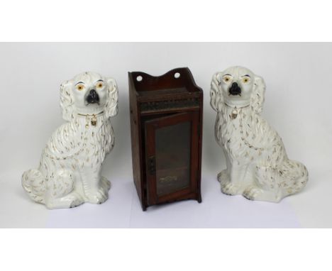 A pair of early 20th century Staffordshire dogs, and a mahogany pipe tobacco box (3).