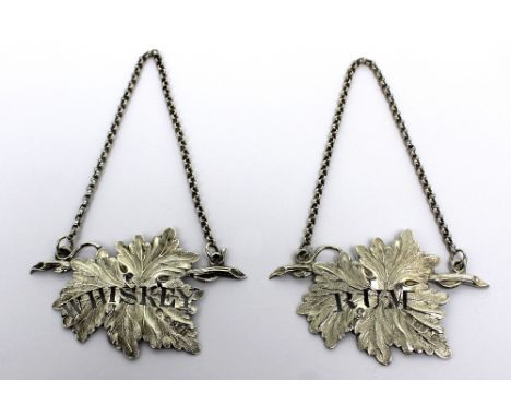 A pair of Victorian hallmarked silver decanter labels modelled as vine leaves, 'Rum' and 'Whisky', Joseph Willmore, Birmingha