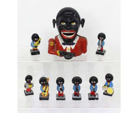 A 'Jolly' cast iron moneybox and a ceramic Golly musical band.