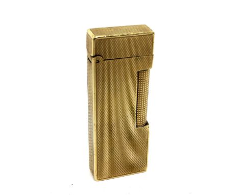 A boxed 9ct yellow gold Dunhill rectangular engine-turned cigarette lighter, length 6.5cm. CONDITION REPORT Has full set of B