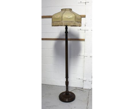 A c1920s mahogany standard lamp with reeded column to circular base, with original c1920s transfer and hand painted-shade, he