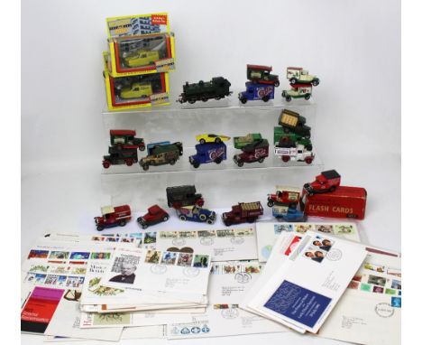 A small collection of diecast vehicles and first day covers.