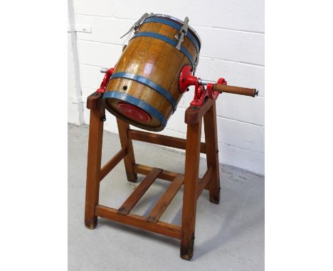 A vintage metal-bound butter churn by R A Lister & Co, Dursley, on stand.