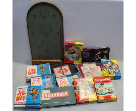 A vintage bagatelle game, also Monopoly and a collection of 1960s jigsaws.