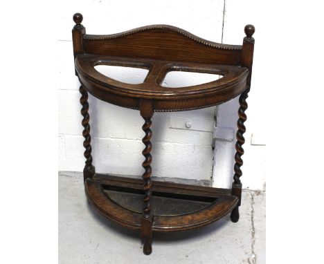 An early 20th century oak hall umbrella stand on wrythen supports, height 76cm and a retro ornate white metal hall table with