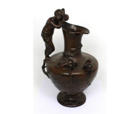 A late 19th century Art Nouveau spelter vase, the handle modelled as a female, the body decorated with cherubs fishing, heigh