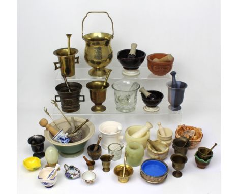 A quantity of mortars and pestles of varying sizes and materials to include brass, glass and ceramic examples.