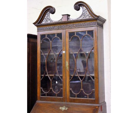 A 19th Century mahogany bureau bookcase with swan neck pediment, the astragal glazed doors enclosing shelves, four long drawe