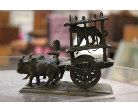 An East Asian bronze of an oxcart with a caged lion