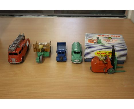 A Boxed Dinky 401 Fork Lift Truck, a Dinky Fire Engine with extending ladder, a Dinky Castrol Oil Tanker, a Dinky Motocart, a