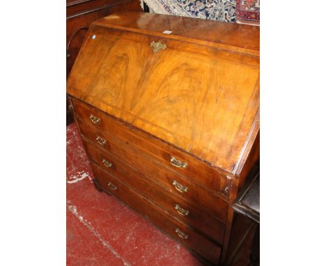 An 18th Century walnut bureau with a fitted interior and four long drawers on bracket feet 94cm wide 