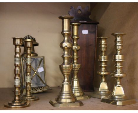 Three pairs of brass candlesticks, a candle box and a lantern 