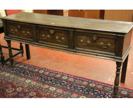 A late 17th/early 18th Century and later oak three drawer dresser with three deep moulded drawers on ring turned front legs 8