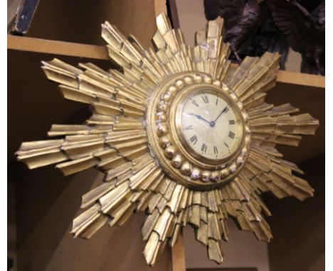 A 20th Century gilt wood sun burst clock, 48cm wide approx.
