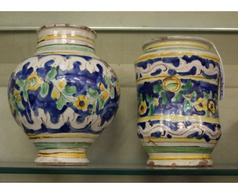 An Italian maiolica albarello, 19th Century, possibly Sicilian or Venetian, painted in shades of blue, green and ochre with f