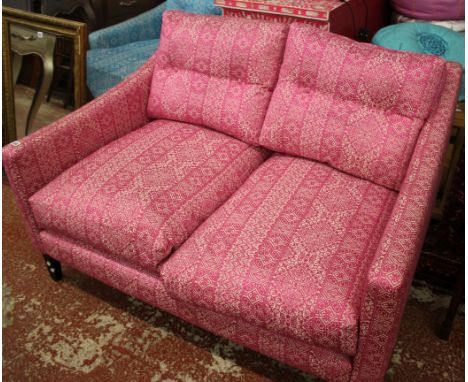 A pink sofa 125cm wide 