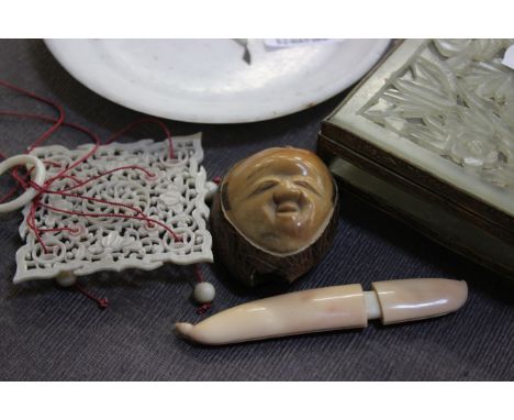 A quantity of Oriental items to include a Japanese nut mask netsuke, an ivory bean pod, an inlaid dish and other items 