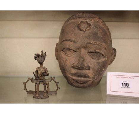 An African terracotta study of a head, and a bronze figure of a man seated possibly Ashanti witch doctor (2)