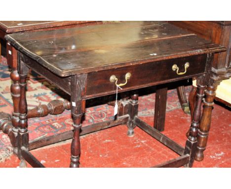 A 17th Century oak side table with a frieze drawer on ring turned and baluster legs joined by stretchers 92cm wide 
