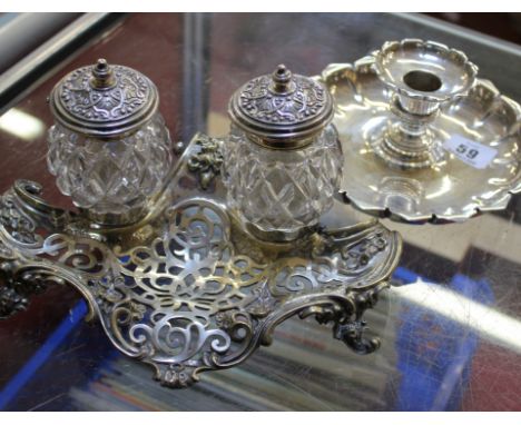 A silver coloured candle holder (marks worn) and an inkwell with silver mounted glass pots on a stand (2)