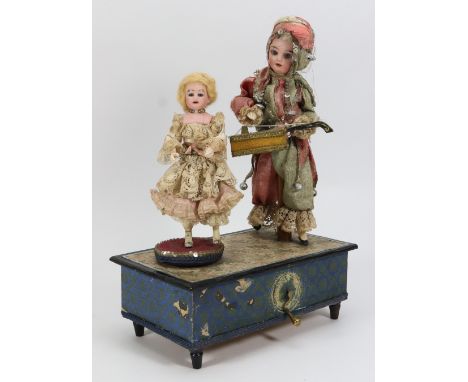 A musical hand wound toy with musician and dancing doll, German circa 1910, bisque head doll holding stringed instrument and 