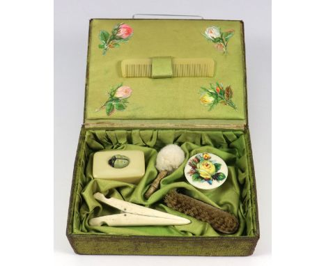 A sweet dolls green velvet vanity case, circa 1910, velvet box with embossed gilt metal and embossed paper decoration, with g