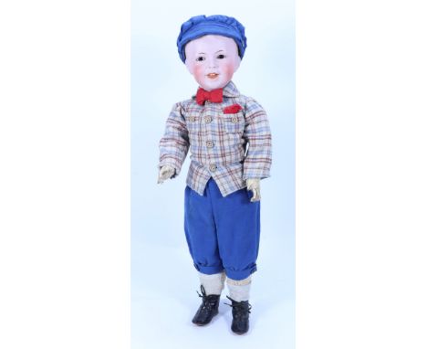 An S.F.B.J 235 bisque head character boy doll, French circa 1910, with fixed brown glass eyes, painted lashes and single stro
