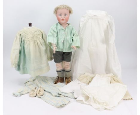 A Kammer & Reinhardt 114 ‘Hans’ bisque head character doll, German circa 1909, with painted blue eyes, single stroke brows, c