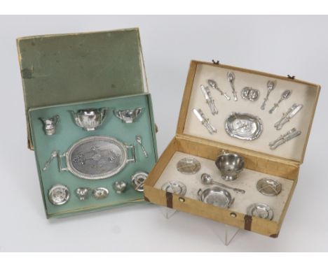 Two original boxed miniature metal dolls dining sets, German circa 1915, the dining set in card picnic hamper with metal clas