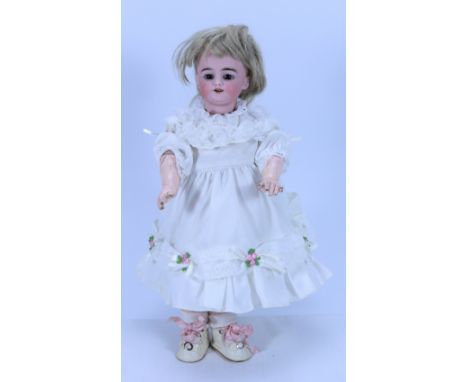 A Simon & Halbig 1009 bisque head doll, German circa 1915, with fixed brown glass eyes, painted lashes and brows, open mouth 