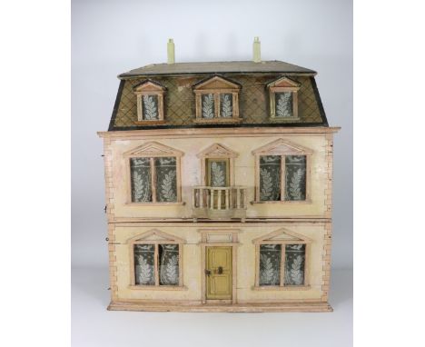 A Christian Hacker three storey dolls house, German circa 1900, the painted sandstone house with painted quoining, glazed win