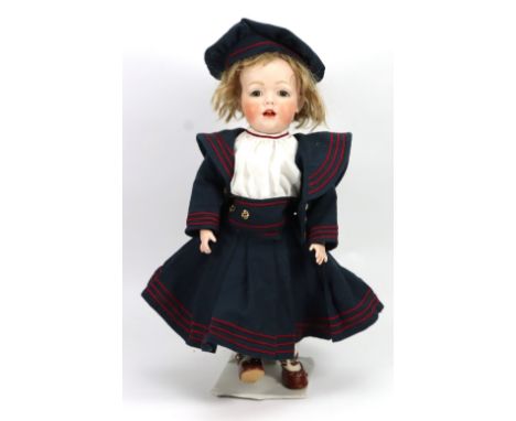 Reproduction J.D.K 237 bisque head doll, with brown glass eyes, open/closed mouth and moulded upper teeth, brown wig, on a fu