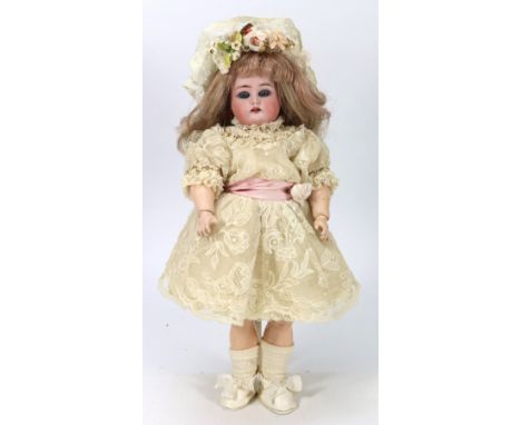 A small Kammer & Reinhardt/S&H bisque head girl doll, German circa 1915, with weighted blue glass eyes, open mouth with upper