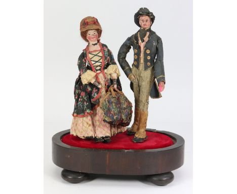 A pair of Edwardian composition shoulder head dolls in original crepe outfits, both with painted features, lady with auburn w