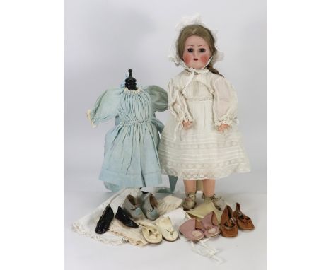 A Kammer & Reinhardt bisque head doll, German circa 1910, with weighted brown glass eyes, painted and real lashes, brows, ope