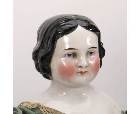 A good and large early glazed china shoulder head doll in original clothes, English circa 1860, with painted features, blue e