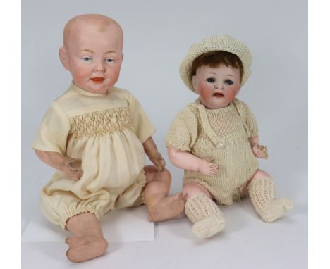 A small Hertal Schwab 152 character baby doll, German circa 1915, with weighted blue glass eyes, open mouth, two upper teeth 