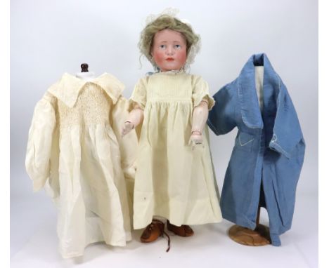 A Kammer & Reinhardt 114 ‘Hans’ bisque head character doll, German circa 1909, with painted blue eyes, single stroke brows, c
