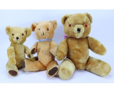 Three post war English Teddy bears, including a golden mohair Farnell bear with orange eyes, black stitched nose, mouth and l